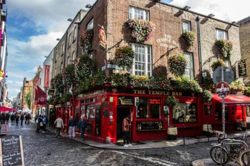 a red pub on a street in front of a building at Central Prime King Size Apartment in Dublin
