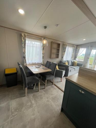 a living room with a dining room table and chairs at The Roecliffe Sea View 9 in Dunoon