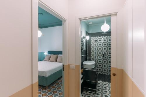 a bedroom with a bed and a mirror at Flat 13 in Sorrento