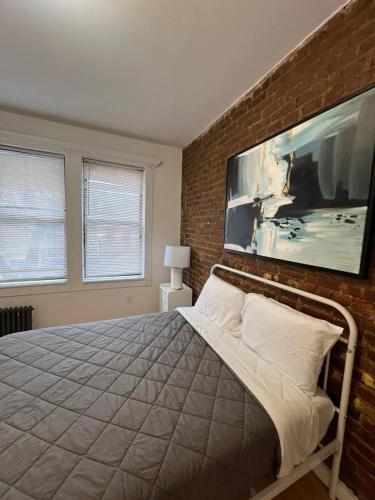 a bedroom with a bed and a brick wall at Apartment in New York By Central Park in New York