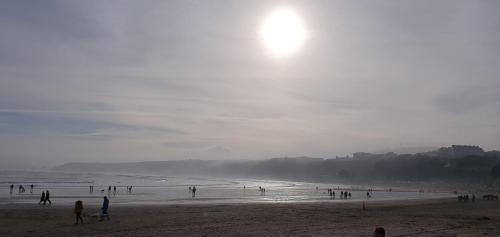 a group of people standing on a beach at St Michael's Guest House in Scarborough