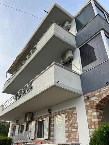 a large building with a balcony on top of it at Guesthouse Butrinti in Ksamil
