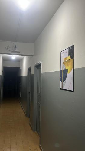 an empty hallway with a painting on the wall at Hotel Centro in Corumbá