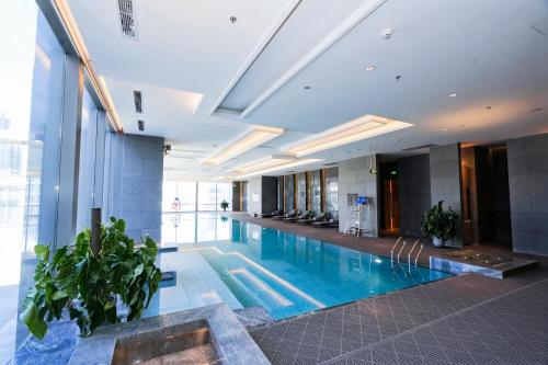 a large swimming pool in a building with plants at JW Marriott Hotel Taiyuan in Taiyuan