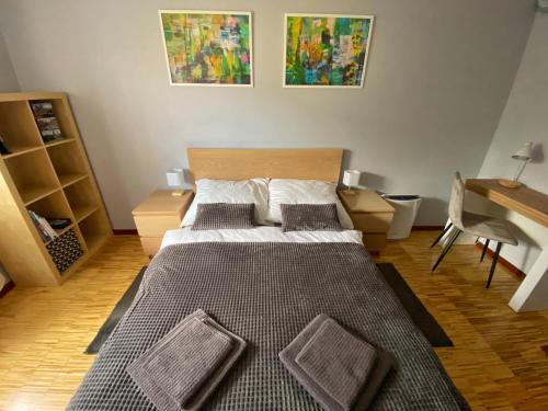 a bedroom with a bed and a desk at Apartament Mosiężna & Taras & Free Parking & Self Check in 24H in Wrocław