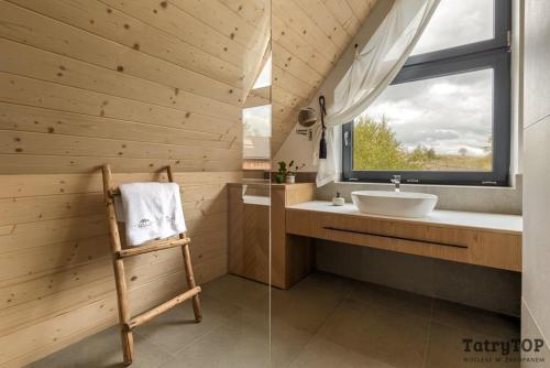 łazienka z umywalką i oknem w obiekcie Czarne Wierchy jacuzzi - Luxury Chalets Kościelisko w mieście Kościelisko