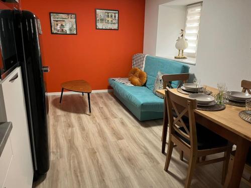 a living room with a blue couch and a table at Chez Mat - 4 pers - Proche Obernai in Bernardswiller