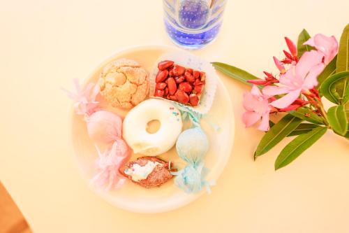a plate of donuts and berries on a table at B&B Villamarina42 in Flumini di Quartu