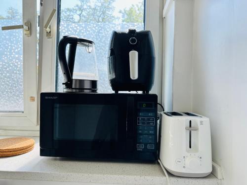 a coffee maker sitting on top of a microwave at One bedroom apartment in Copenhagen