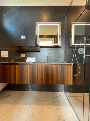 a bathroom with a sink and a mirror at Jesolo Luxury Suites in Jesolo