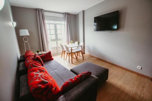 a living room with a couch and a television at LAR DA REVOLTA in Cedeira