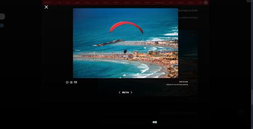 a television screen with a picture of a beach at Beach Front Apartment in Netanya