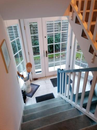 a staircase in a house with doors and windows at Kampweg 1 Wohnung 2 in Cuxhaven