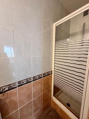 une douche avec une porte vitrée dans une salle de bain dans l'établissement Garden in Nice Mont Boron, à Nice