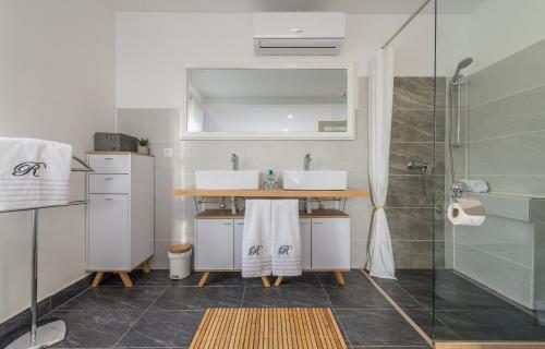 a bathroom with two sinks and a shower at Villa Rita II in Senj