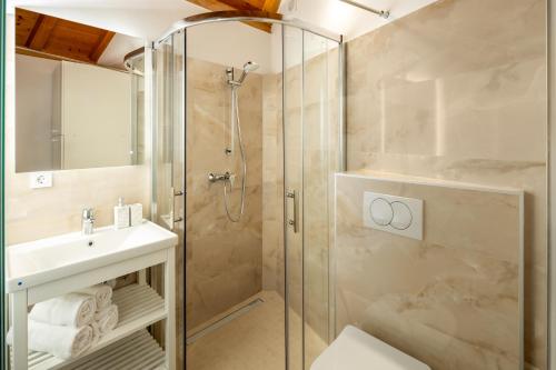 a bathroom with a shower and a toilet and a sink at Villa Casa di Perla in Primošten