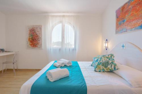 a bedroom with two rolled towels on a bed at B&B Villamarina42 in Flumini di Quartu