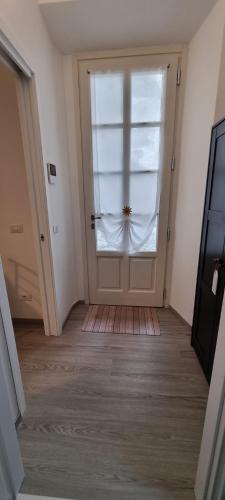a hallway with a door with a window at Suite Arianna in Cannobio