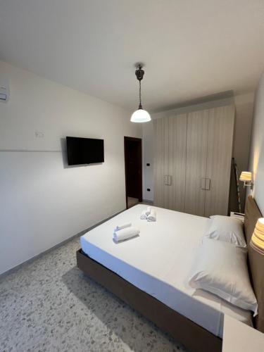 a bedroom with a large bed with a tv on the wall at Sweet Home Capodimonte in Naples