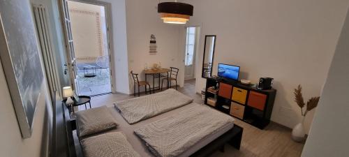 a living room with a bed and a television at Suite Arianna in Cannobio