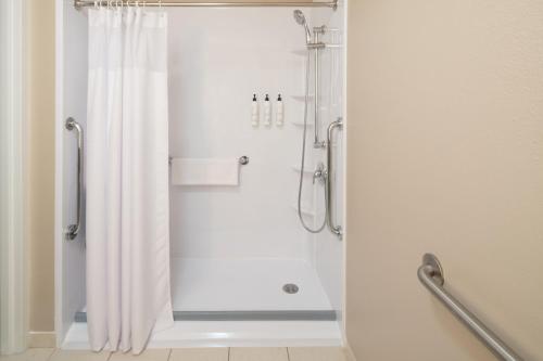 um chuveiro com uma cortina de chuveiro branca na casa de banho em SpringHill Suites by Marriott Charleston Riverview em Charleston