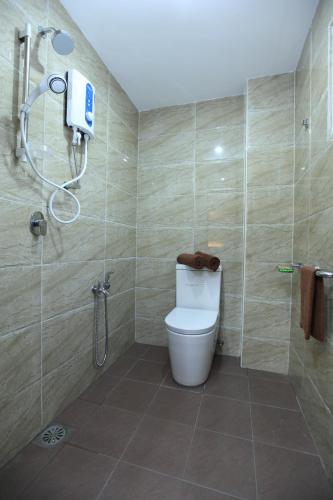 a bathroom with a toilet and a shower at Al Huda Hotel in Malacca