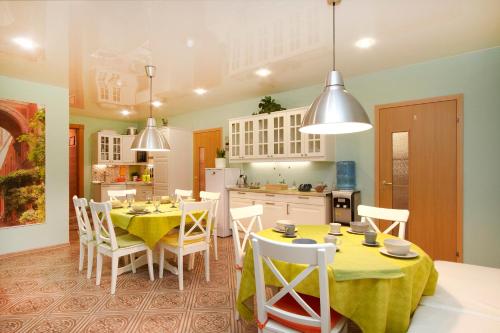a kitchen and dining room with a table and chairs at Mini-hotel Sofia in Saint Petersburg
