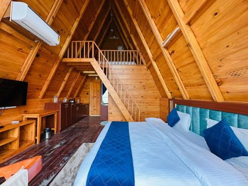 a bedroom with a large bed with a wooden ceiling at The Lake Ambience Resort in Bhīm Tāl