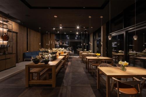 a restaurant with wooden tables and chairs and flowers at Cherot in Krymno