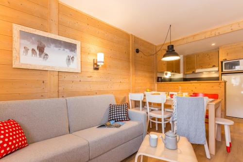 un salon avec un canapé et une table dans l'établissement Résidence Pierre & Vacances Aconit, aux Menuires