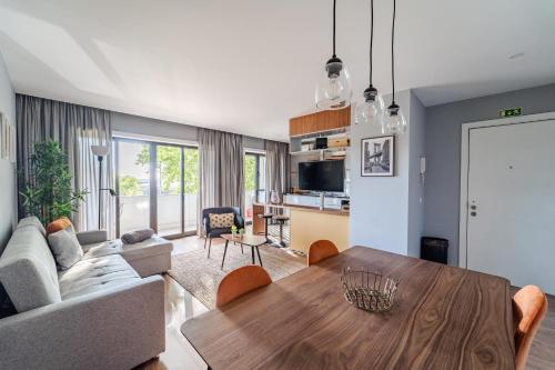 a living room with a table and a couch at Norton Matos - T2 in the heart of Braga by House and People in Braga