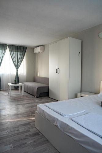 a bedroom with a large bed and a white cabinet at Saint Anastasia lozenets in Lozenets