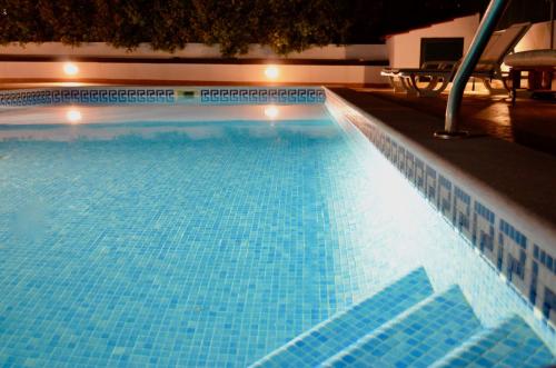 a large swimming pool with blue tiles on it at Villa ELTAEL - Miguel House - Warm Pool from April 2026- Facilities for Disabled Guests in Manta Rota