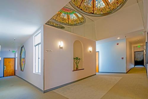 a room with stained glass ceilings and a hallway at Grant Plaza Hotel in San Francisco