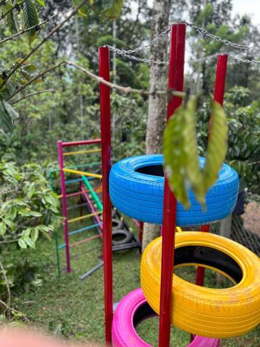 a stack of colorful tires on a playground at SylVan Resort in Wayanad