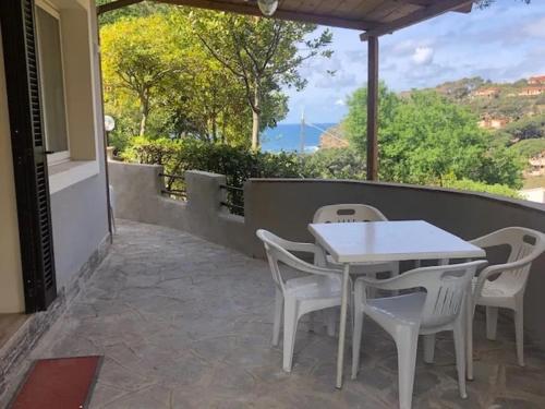 a white table and chairs on a patio at Appartamenti Pagni in Casa Morcone