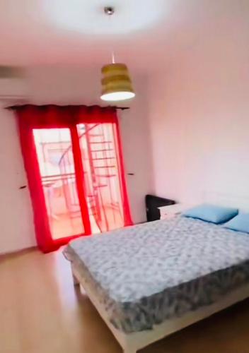 a bedroom with a bed and a red window at Marina Saïdia AP 2 in Cherarba