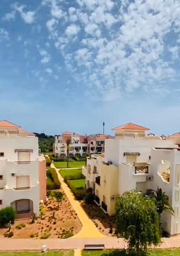 a view of two white apartment buildings with a sky at Marina Saïdia AP 2 in Cherarba