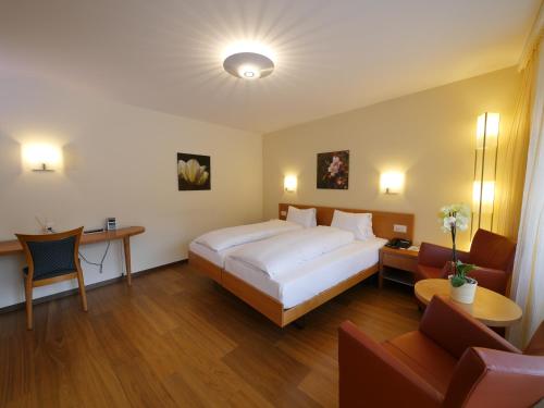 um quarto com uma grande cama branca num quarto em Hotel Restaurant Eichberg em Seengen
