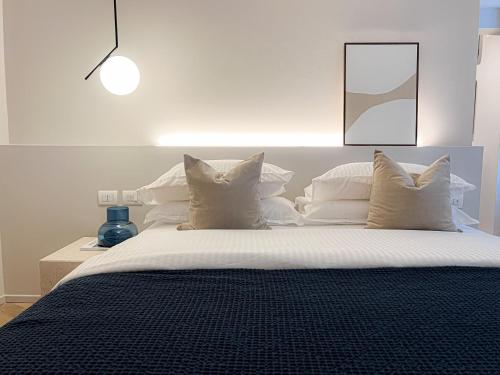 a bedroom with a large bed with white pillows at Sweet Menaggio in Menaggio