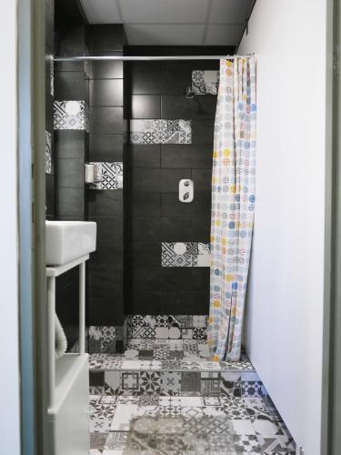 a bathroom with a sink and a shower at Choco Home & Hostel in Cluj-Napoca