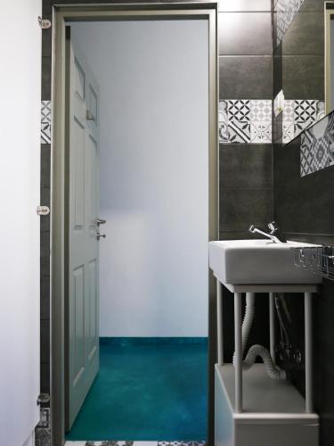 a bathroom with a white sink and a mirror at Choco Home & Hostel in Cluj-Napoca