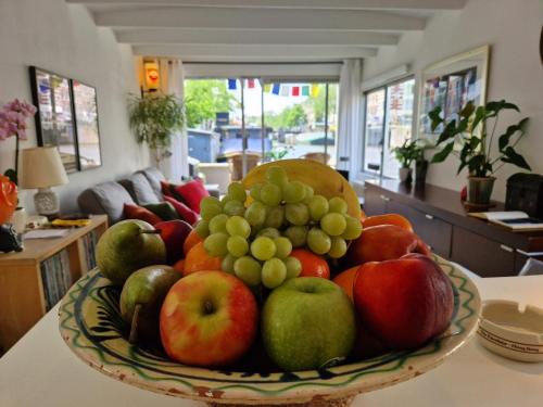a bowl of fruit sitting on a table at Pantheos Top Houseboat in Amsterdam