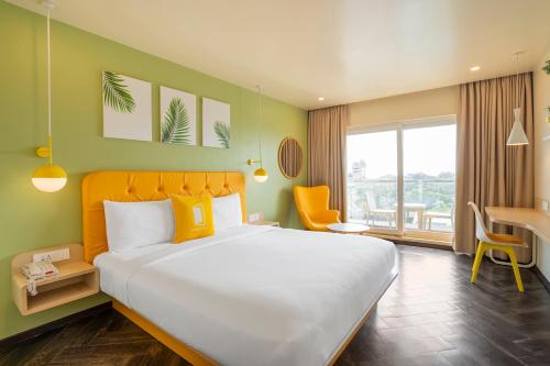 Un pat sau paturi într-o cameră la Bloom Hotel - Dona Paula