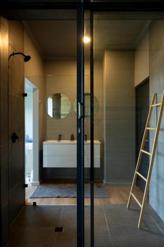 a bathroom with a bath tub and a ladder at Askop Hilltop Farm House The Crags Plettenberg Bay in The Crags