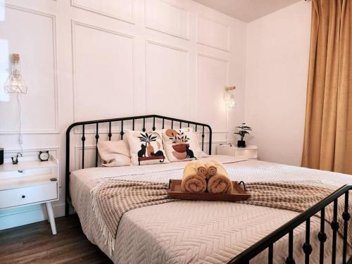 a bedroom with a bed with a tray with towels on it at Antique CAT - 2 King Bed & Hot Tub - Free Parking in Quebec City