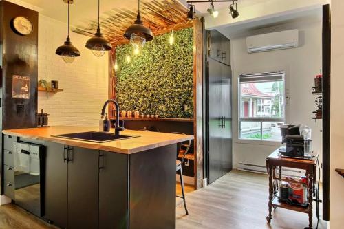 a kitchen with a sink and a large green wall at Antique CAT - 2 King Bed & Hot Tub - Free Parking in Quebec City