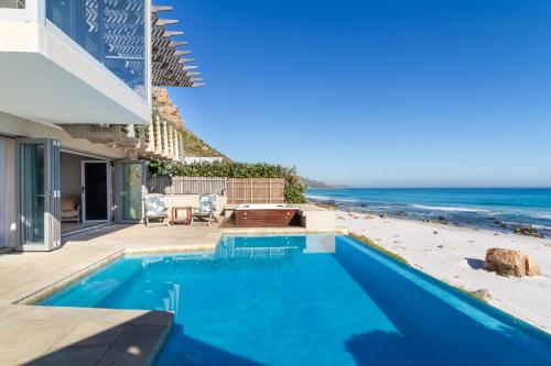 a swimming pool with a view of the beach at Villa Misty Cliffs in Scarborough