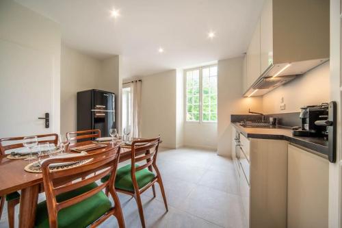 une salle à manger avec une table et des chaises et une cuisine dans l'établissement Château de Dracy L Élégante, à Dracy-le-Fort
