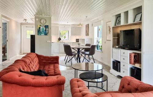 a living room with two couches and a table at 2 Bedroom Beautiful Apartment In Floda in Floda